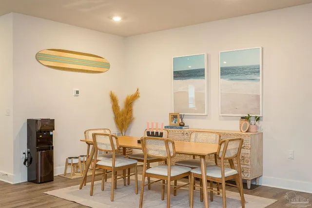 a dining room with furniture and wooden floor