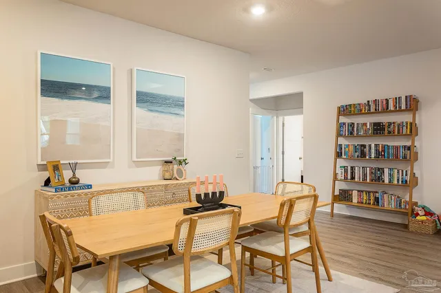 a dining room with furniture and wooden floor