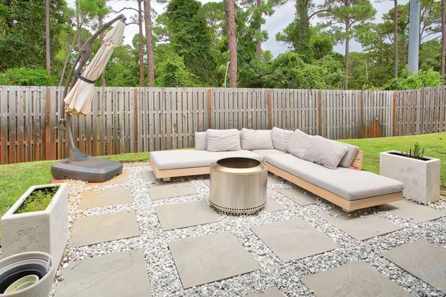a view of a patio with couches and a fire pit