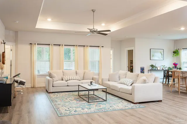 a living room with furniture and a chandelier