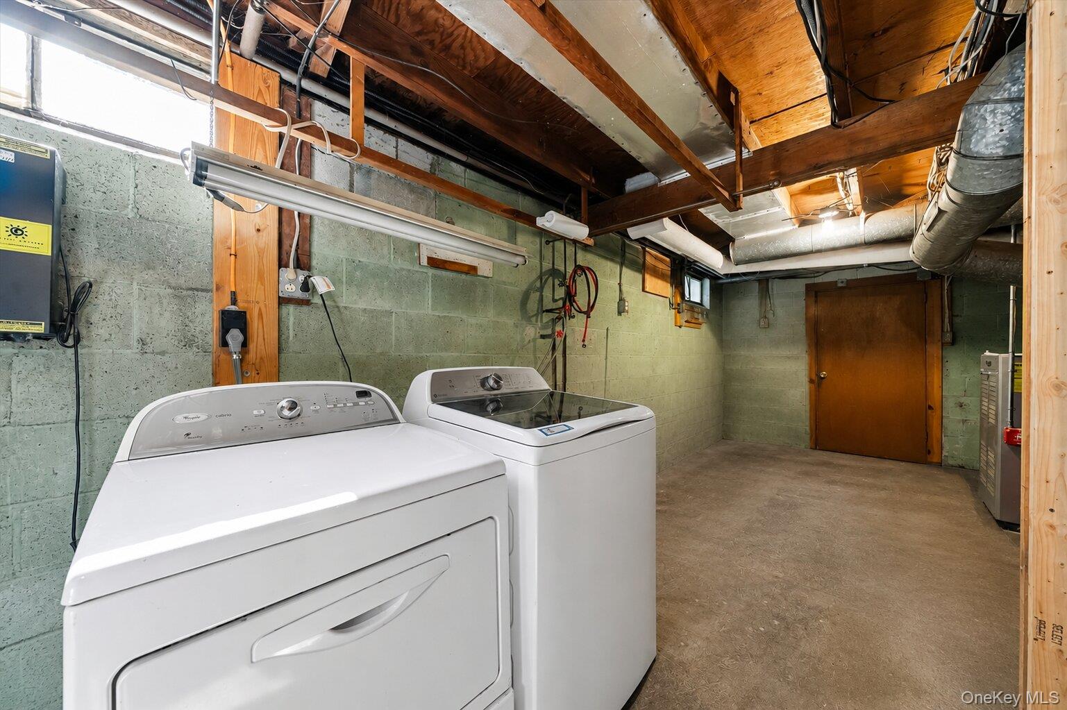 49 Chase Road Wallkill, NY 12589 - Photo 24 of 32 Clean lower-level utility space with laundry connections, heating equipment, storage potential, and access to the staircase.