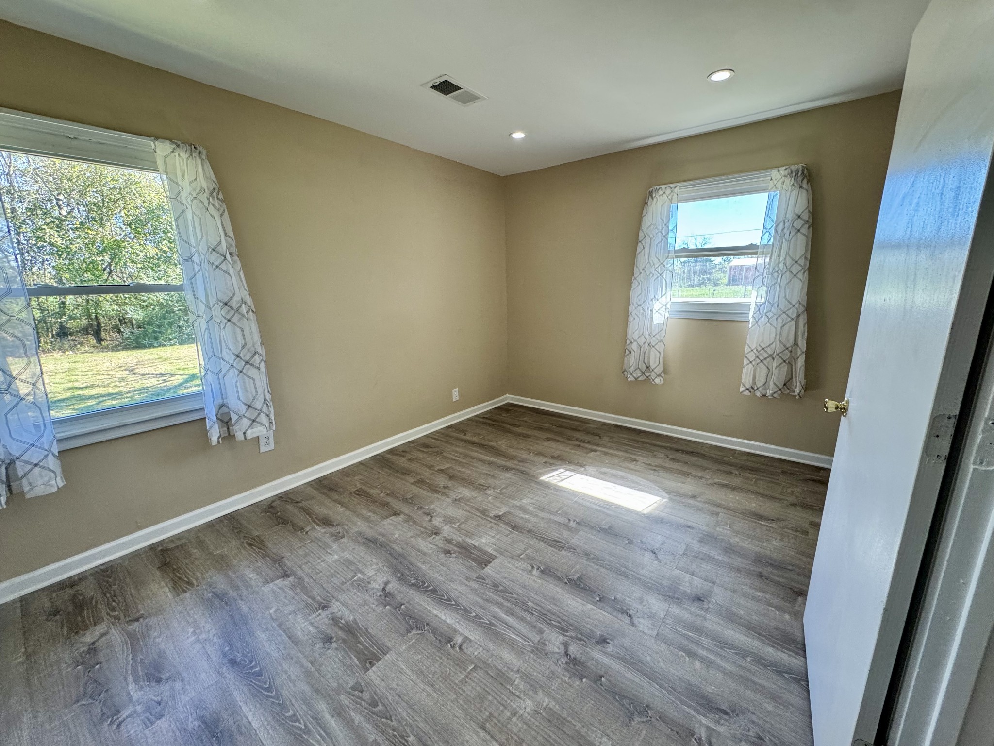 369 Burford Road Lebanon, TN 37087 - Photo 14 of 25 an empty room with wooden floor and windows