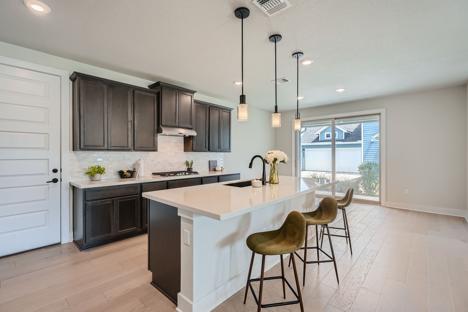 8319 Laughlin Lane Austin, TX 78744 - Photo 6 of 26 The kitchen is complete with a large island with quartz countertops and plenty of space for meal prep and casual dining.
