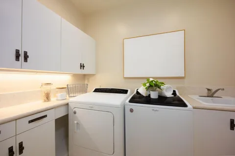an aerial view of residential houses with outdoor space and trees