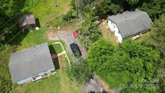 an aerial view of a house with a yard and outdoor seating