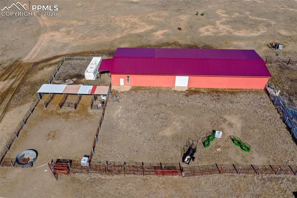 a view of balcony with two chairs and potted plants