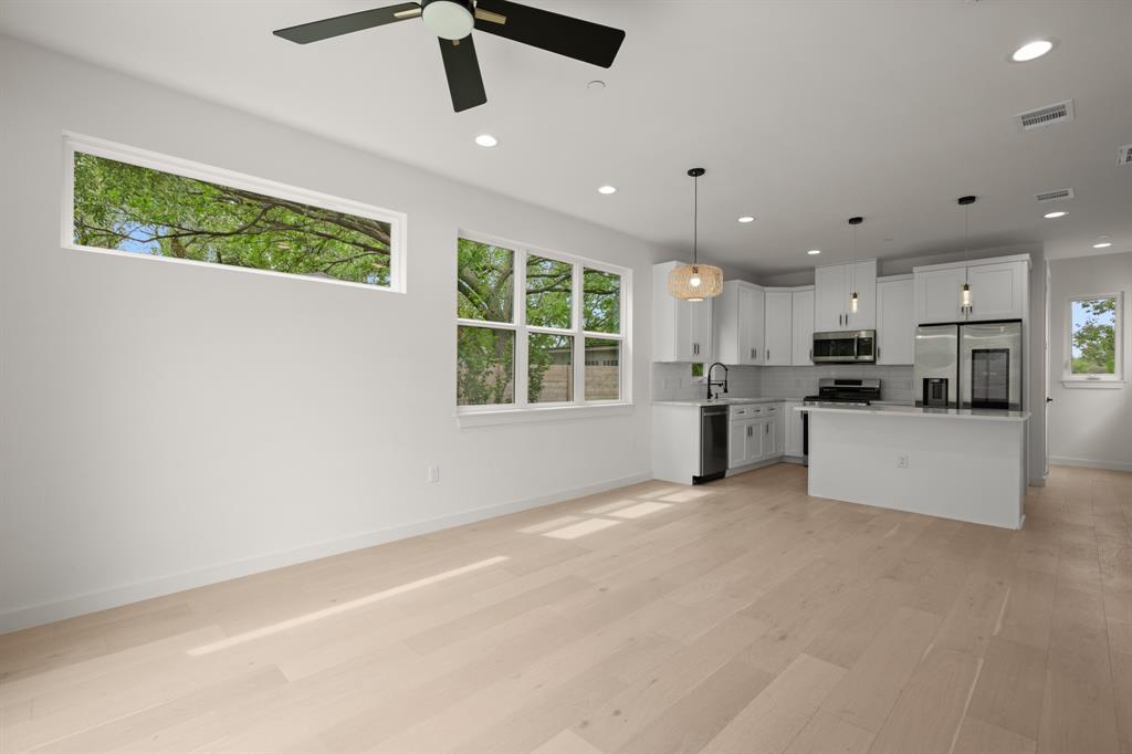 5305 Ledesma Road, Unit 4 Austin, TX 78721 - Photo 10 of 27 a view of a kitchen with kitchen island wooden floor center island and stainless steel appliances