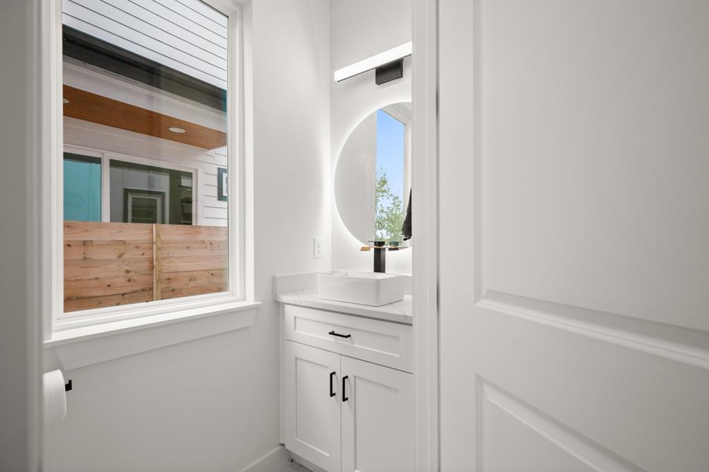 5305 Ledesma Road, Unit 4 Austin, TX 78721 - Photo 12 of 27 a bathroom with a window a sink and a mirror