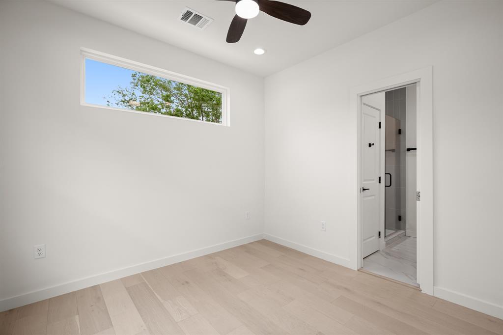 5305 Ledesma Road, Unit 4 Austin, TX 78721 - Photo 15 of 27 an empty room with a ceiling fan and a window