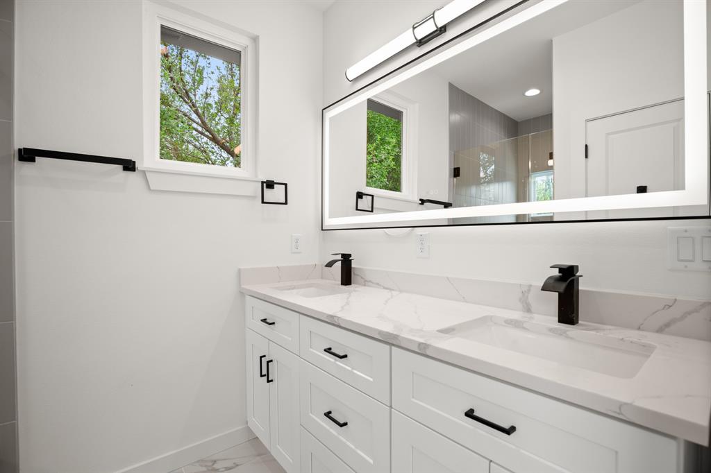 5305 Ledesma Road, Unit 4 Austin, TX 78721 - Photo 17 of 27 a bathroom with a sink and a mirror