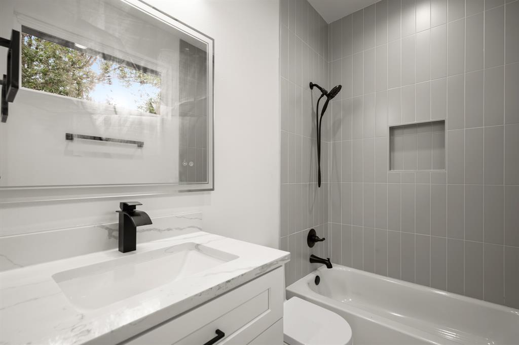 5305 Ledesma Road, Unit 4 Austin, TX 78721 - Photo 20 of 27 a bathroom with a sink a toilet and a shower