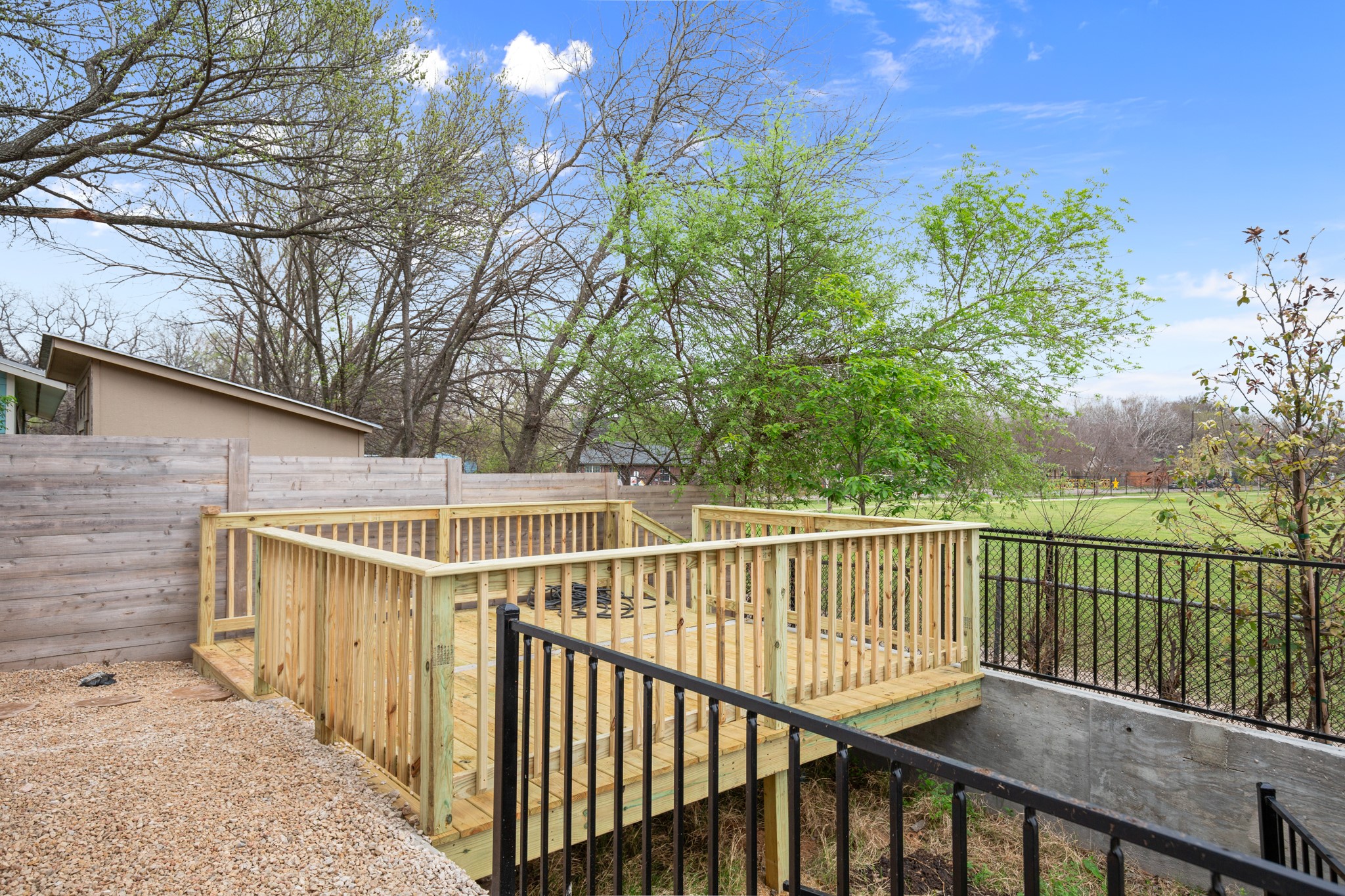 5305 Ledesma Road, Unit 4 Austin, TX 78721 - Photo 23 of 27 a view of a wooden balcony with an outdoor space