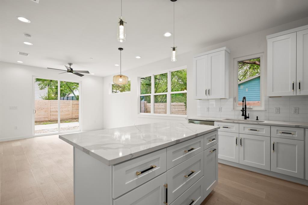 5305 Ledesma Road, Unit 4 Austin, TX 78721 - Photo 6 of 27 a kitchen with a stove sink and cabinets
