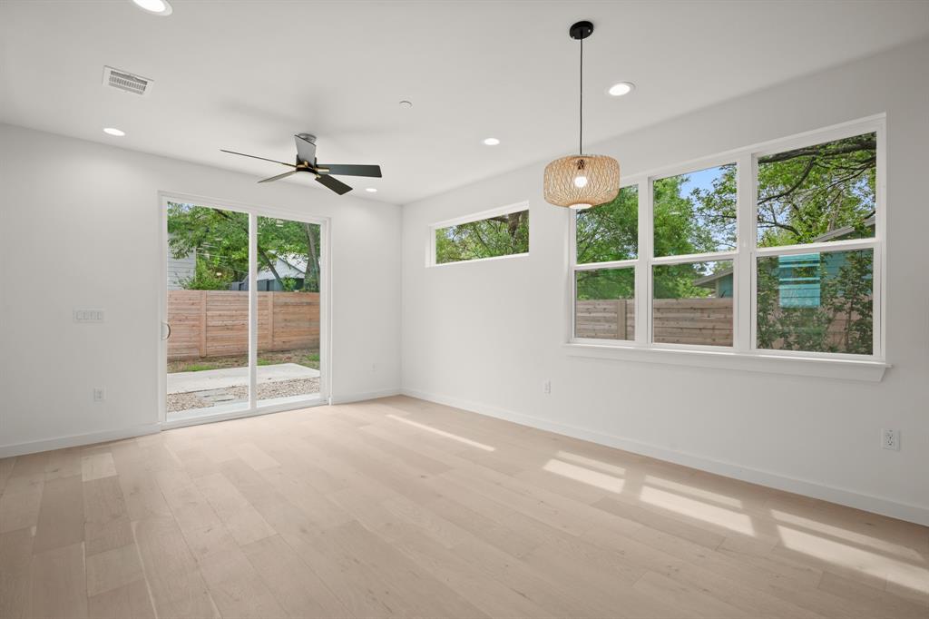 5305 Ledesma Road, Unit 4 Austin, TX 78721 - Photo 9 of 27 a view of an empty room with windows and ceiling fan