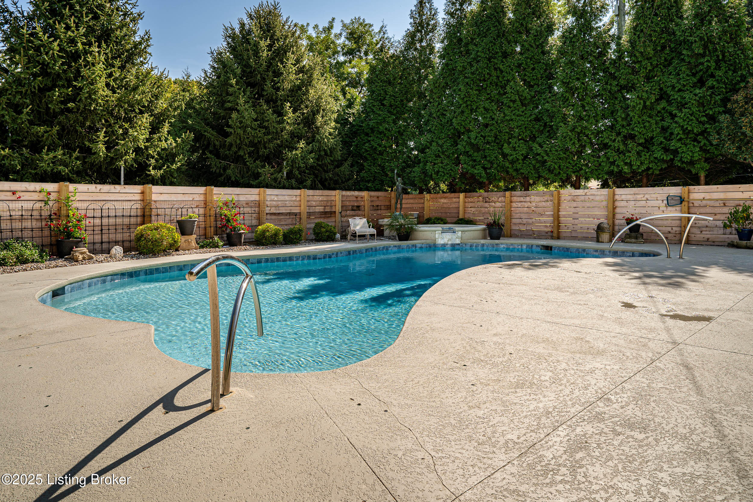 4228 River Road Louisville, KY 40207 - Photo 15 of 81 The property's private backyard retreat features a stunning pool, hot tub, and bar.