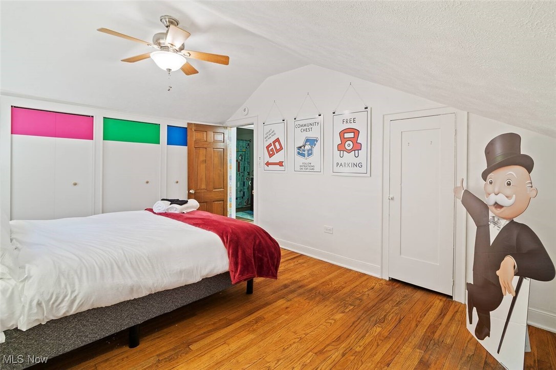 47 Prospect Road Berea, OH 44017 - Photo 19 of 23 Bedroom featuring wood finished floors, vaulted ceiling, ceiling fan, and a textured ceiling