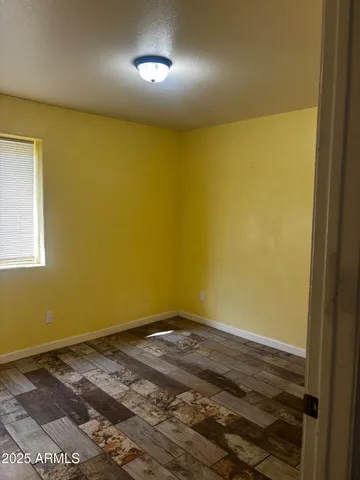 a view of a room with a wooden floor