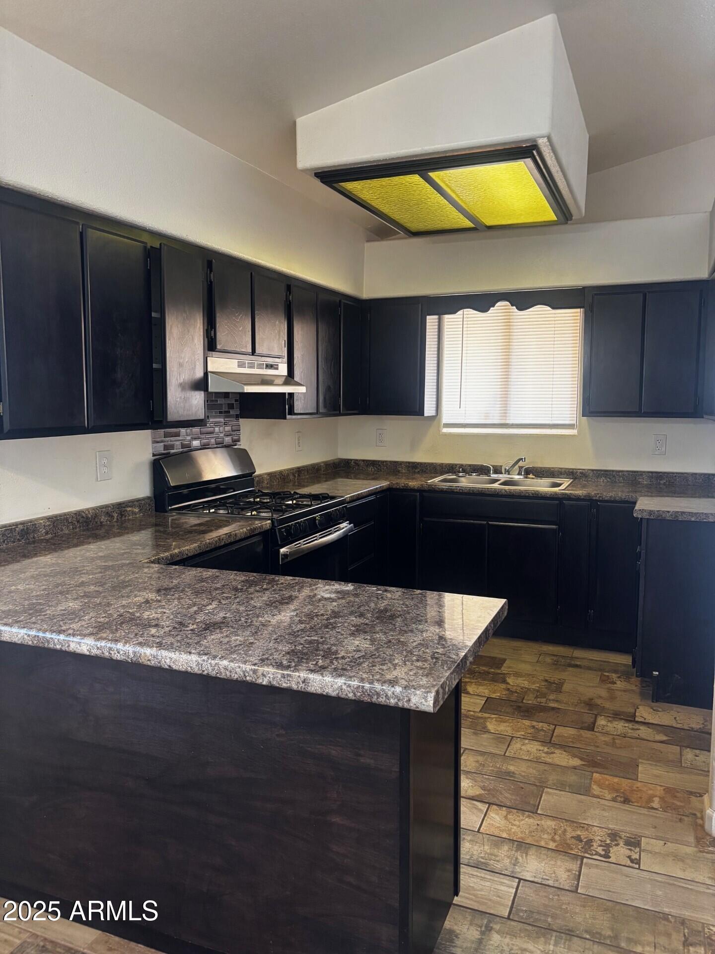 814 East 13th Street Douglas, AZ 85607 - Photo 3 of 14 a kitchen with stainless steel appliances granite countertop a sink and a stove