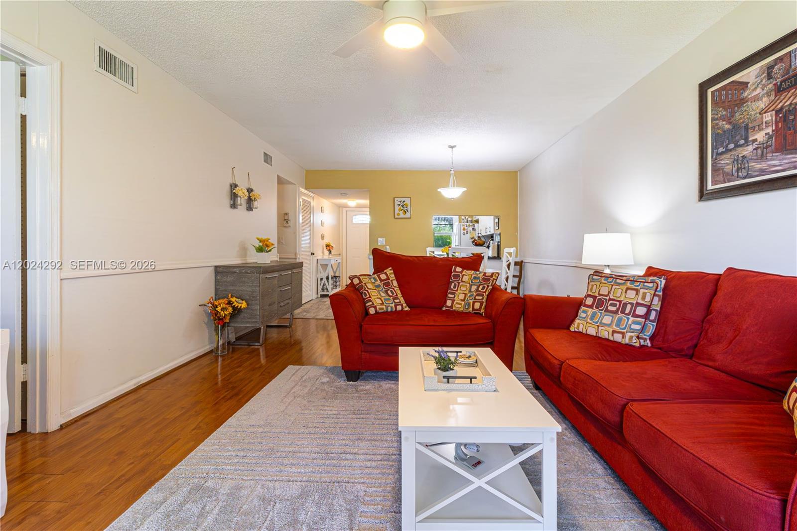 9780 Marina Boulevard, Unit 424 Boca Raton, FL 33428 - Photo 12 of 32 a living room with furniture and a wooden floor