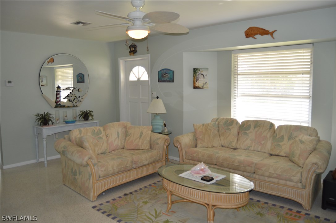2822 Bruce Street Cape Coral, FL 33993 - Photo 11 of 20 a living room with furniture and a large mirror
