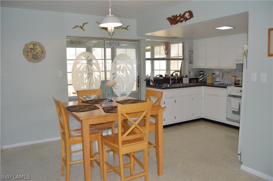 2822 Bruce Street Cape Coral, FL 33993 - Photo 16 of 20 a kitchen with a table and chairs in it