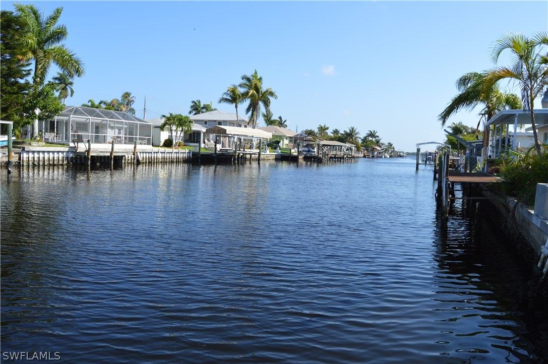 2822 Bruce Street Cape Coral, FL 33993 - Photo 5 of 20 a view of a lake with boats and palm trees