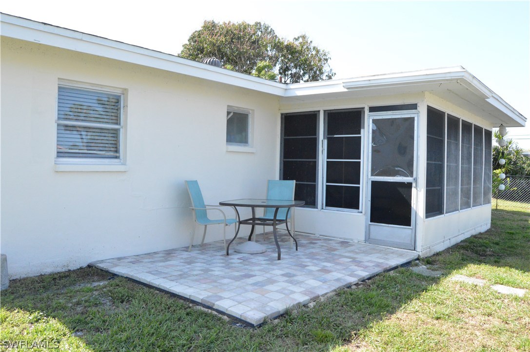 2822 Bruce Street Cape Coral, FL 33993 - Photo 6 of 20 a front view of a house with a yard and seating space