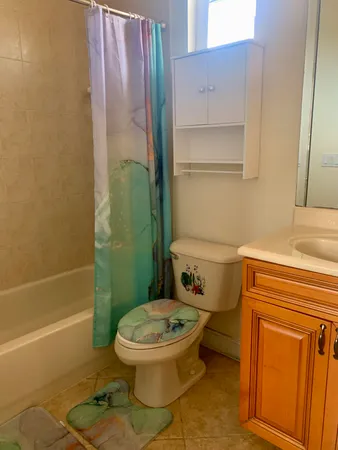 a bathroom with a toilet and a shower