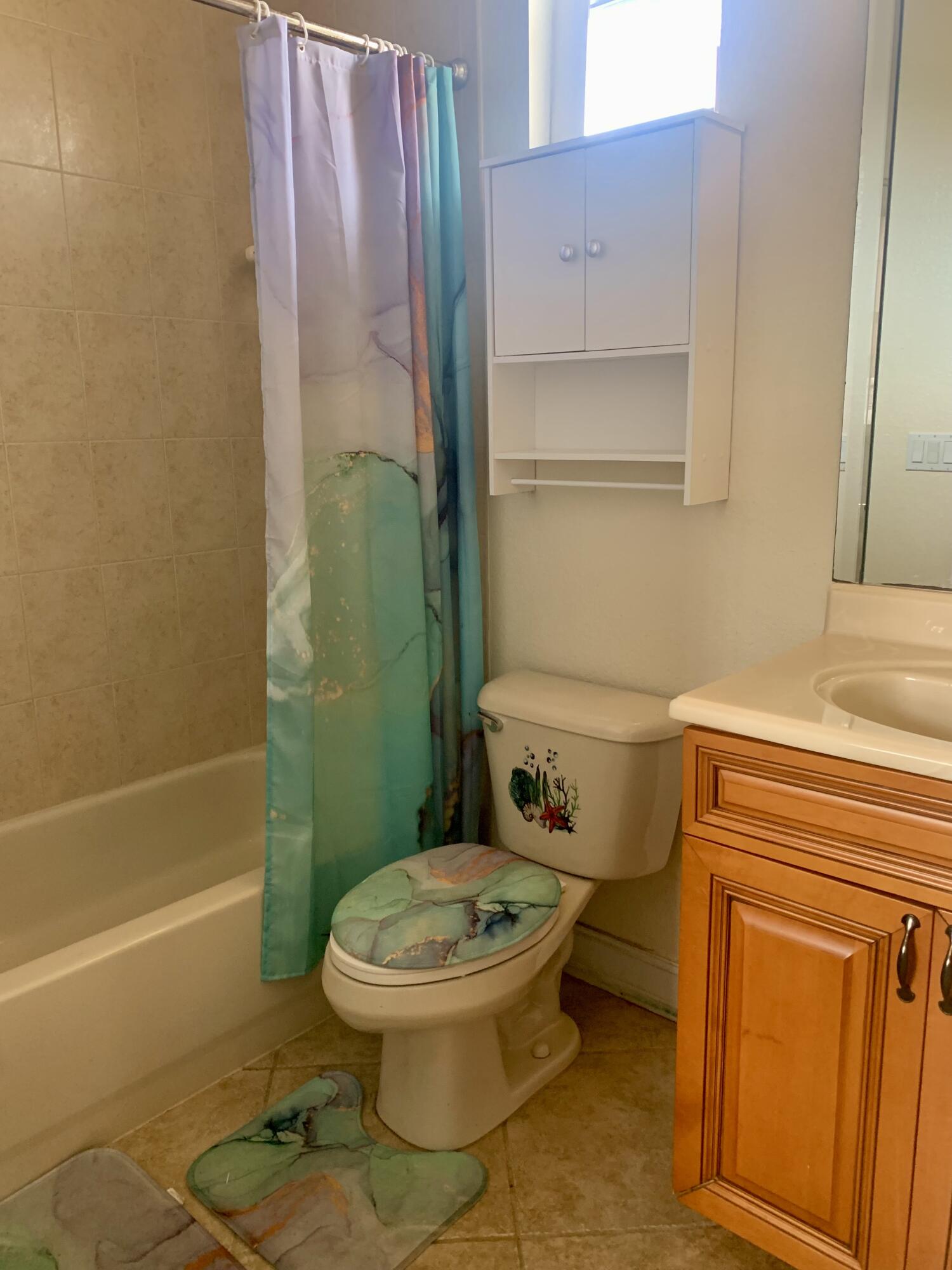 2215 Hypoluxo Road Lantana, FL 33462 - Photo 11 of 49 a bathroom with a toilet and a shower