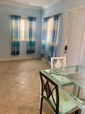 a living room with a table and chairs