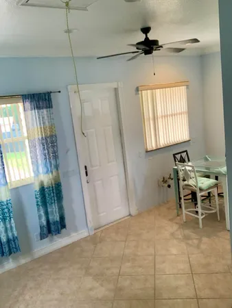 a view of a livingroom with furniture and a window