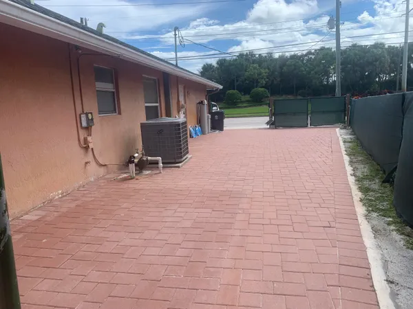 a backyard of a house with table and chairs