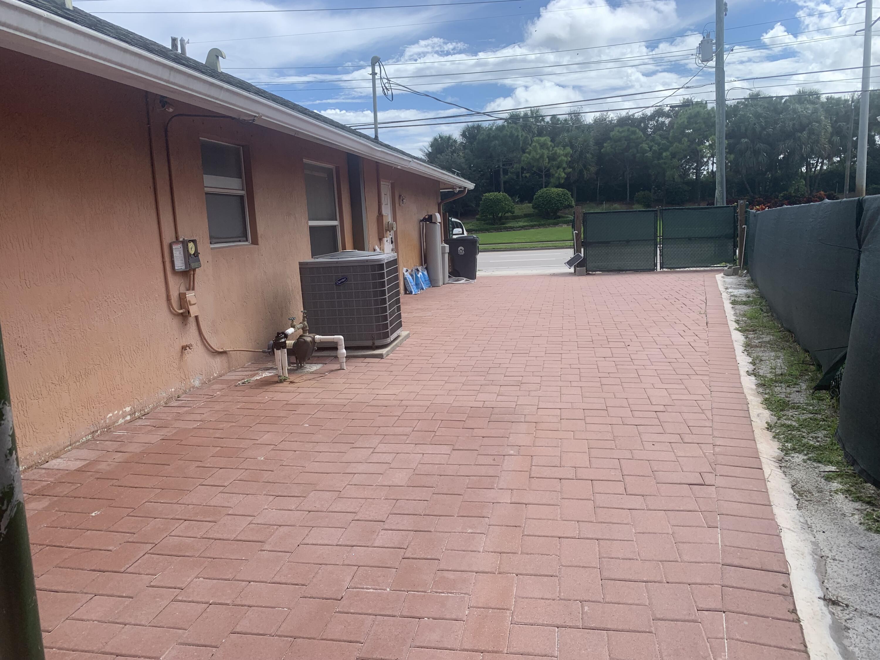 2215 Hypoluxo Road Lantana, FL 33462 - Photo 18 of 49 a view of a patio with a table and chairs with wooden floor