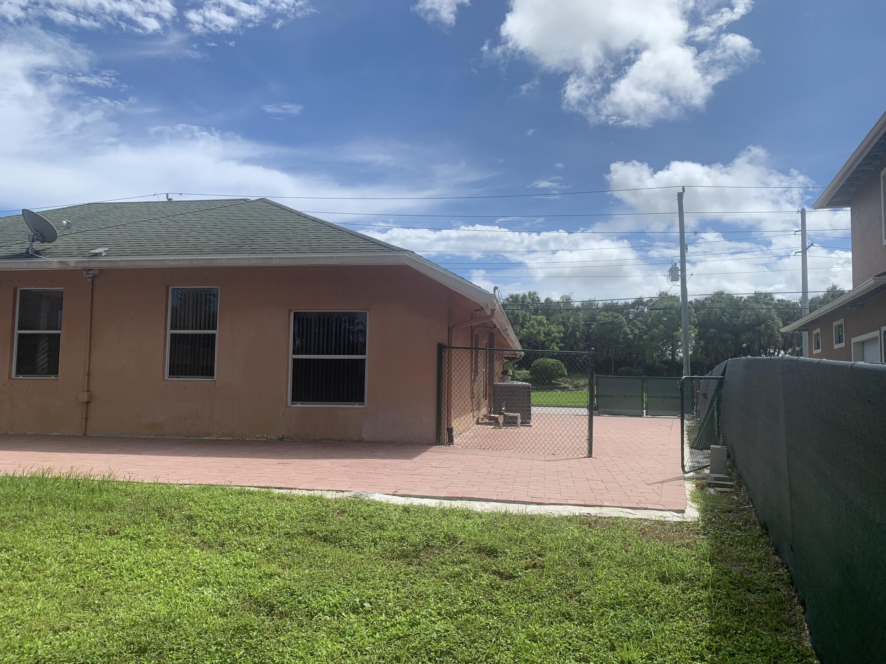 2215 Hypoluxo Road Lantana, FL 33462 - Photo 19 of 49 a backyard of a house with table and chairs