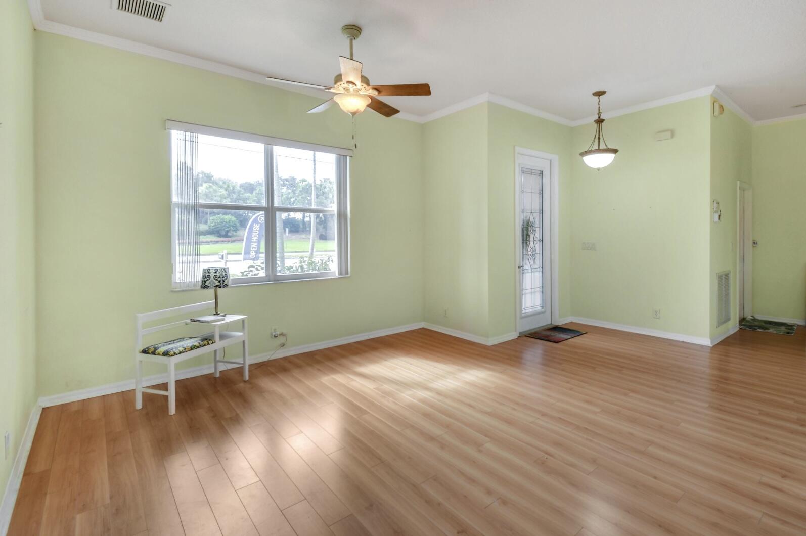 2215 Hypoluxo Road Lantana, FL 33462 - Photo 20 of 49 a view of an empty room with wooden floor and a window