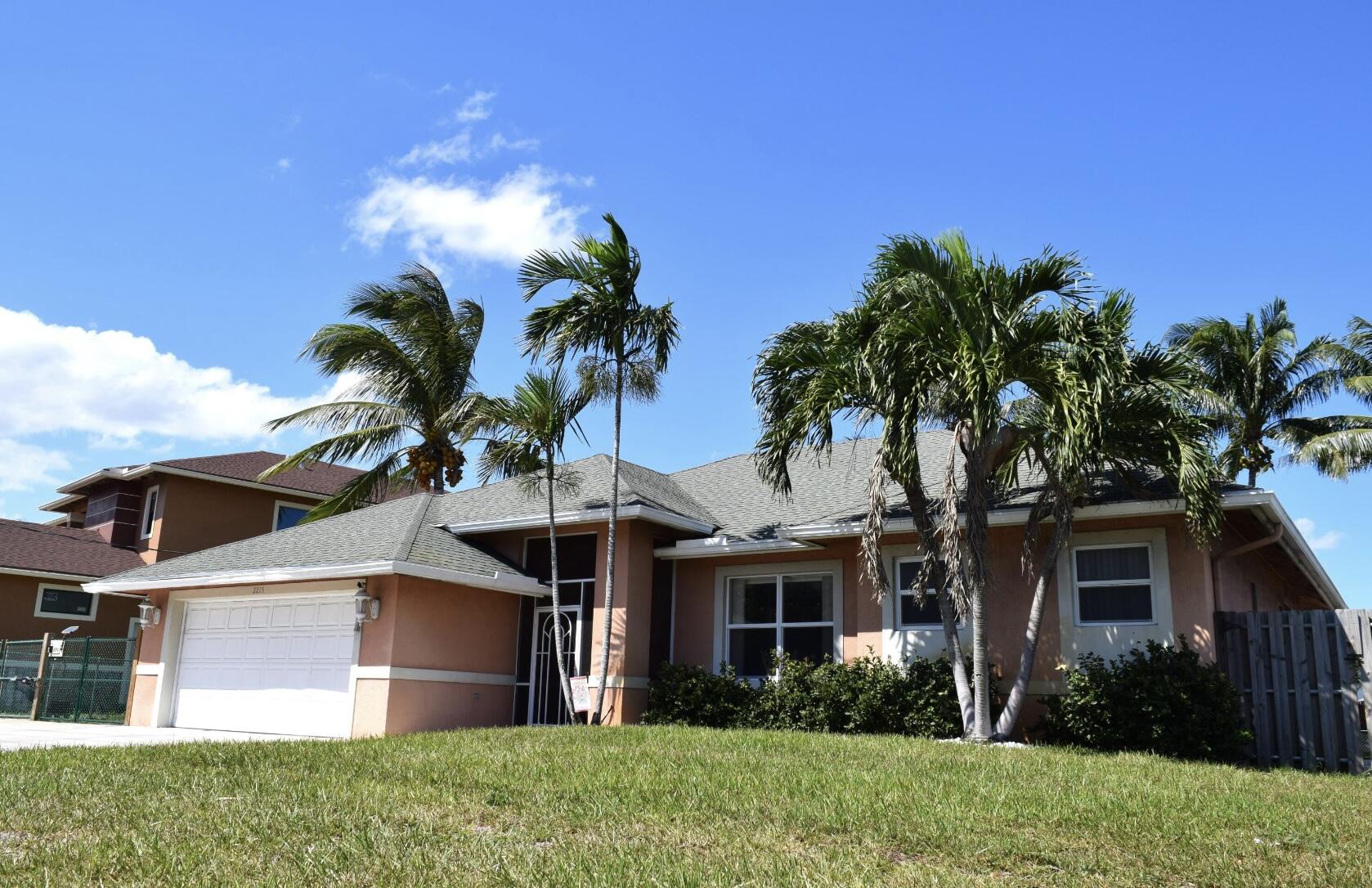2215 Hypoluxo Road Lantana, FL 33462 - Photo 2 of 49 a view of a house with a yard and a garden