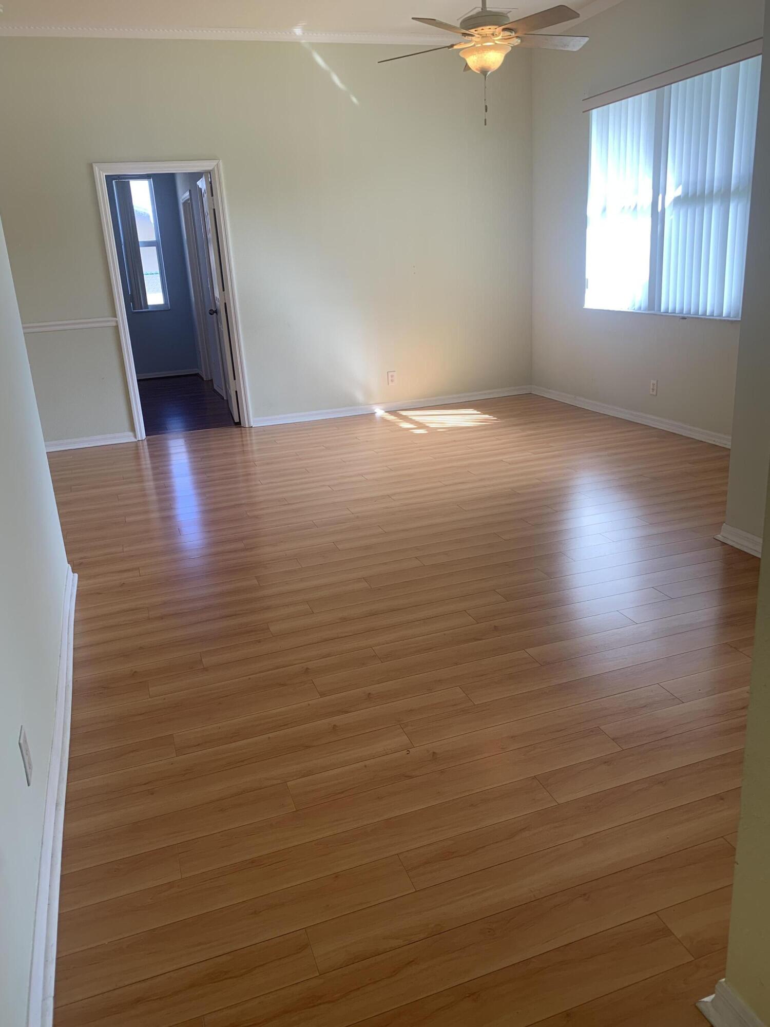 2215 Hypoluxo Road Lantana, FL 33462 - Photo 25 of 49 wooden floor in an empty room with a window