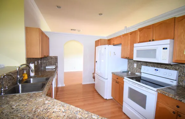 a kitchen with stainless steel appliances a refrigerator and cabinets