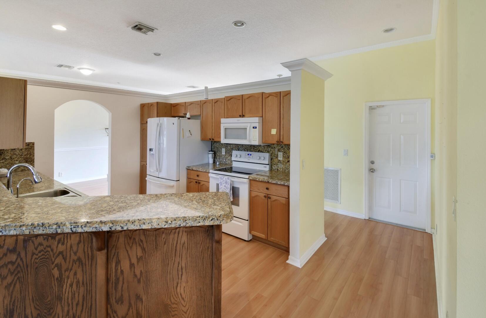 2215 Hypoluxo Road Lantana, FL 33462 - Photo 29 of 49 a kitchen with a sink refrigerator and microwave