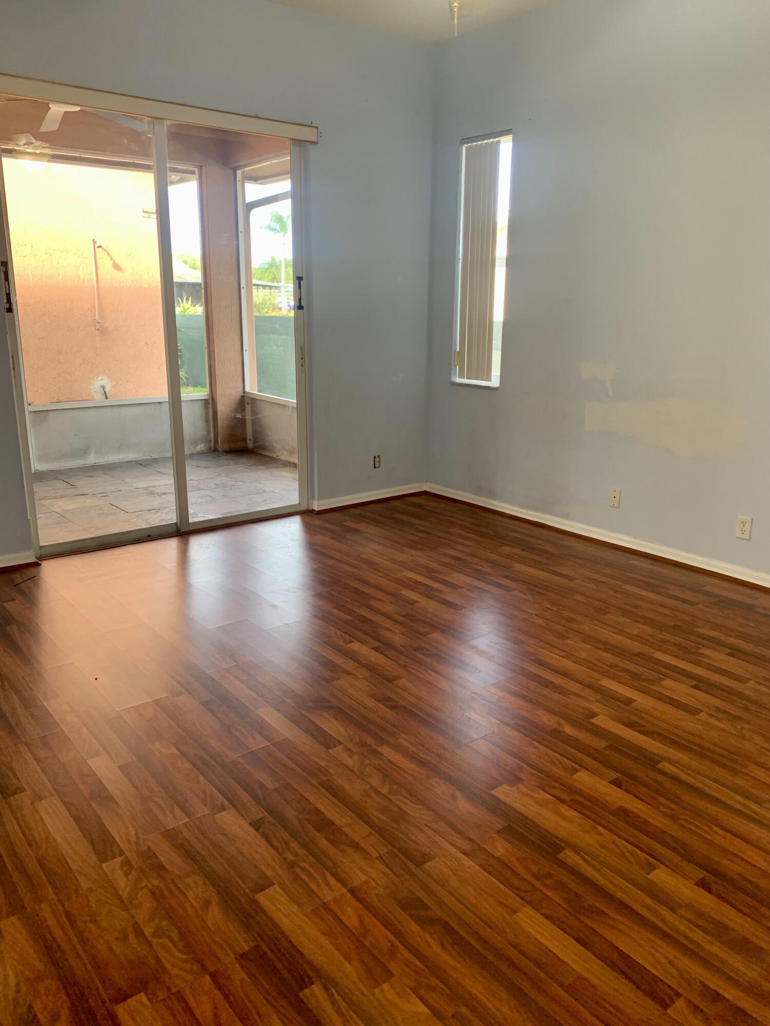 2215 Hypoluxo Road Lantana, FL 33462 - Photo 30 of 49 a view of an empty room with wooden floor and a window
