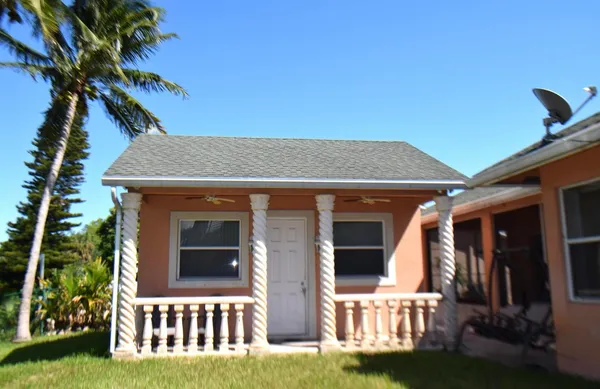 a view of a house with a small yard and plants