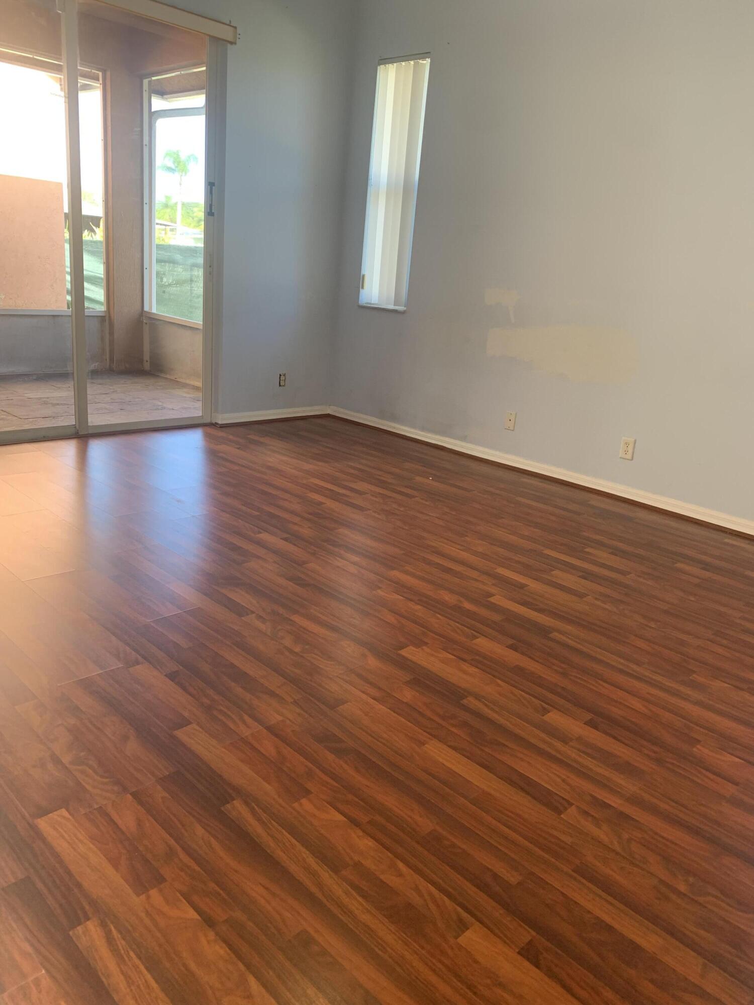 2215 Hypoluxo Road Lantana, FL 33462 - Photo 32 of 49 wooden floor in an empty room with a window