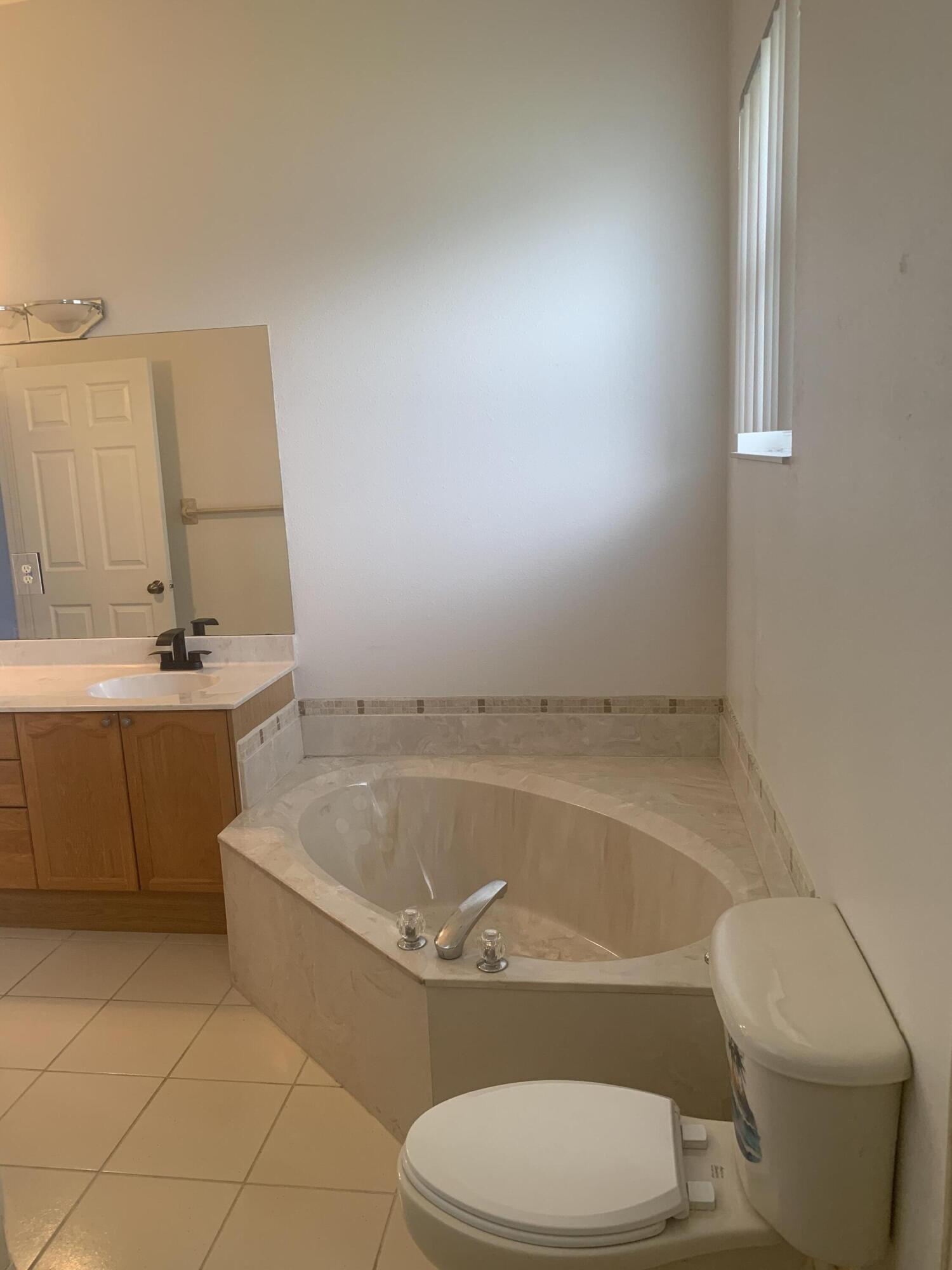 2215 Hypoluxo Road Lantana, FL 33462 - Photo 35 of 49 a bathroom with a sink a toilet and bathtub