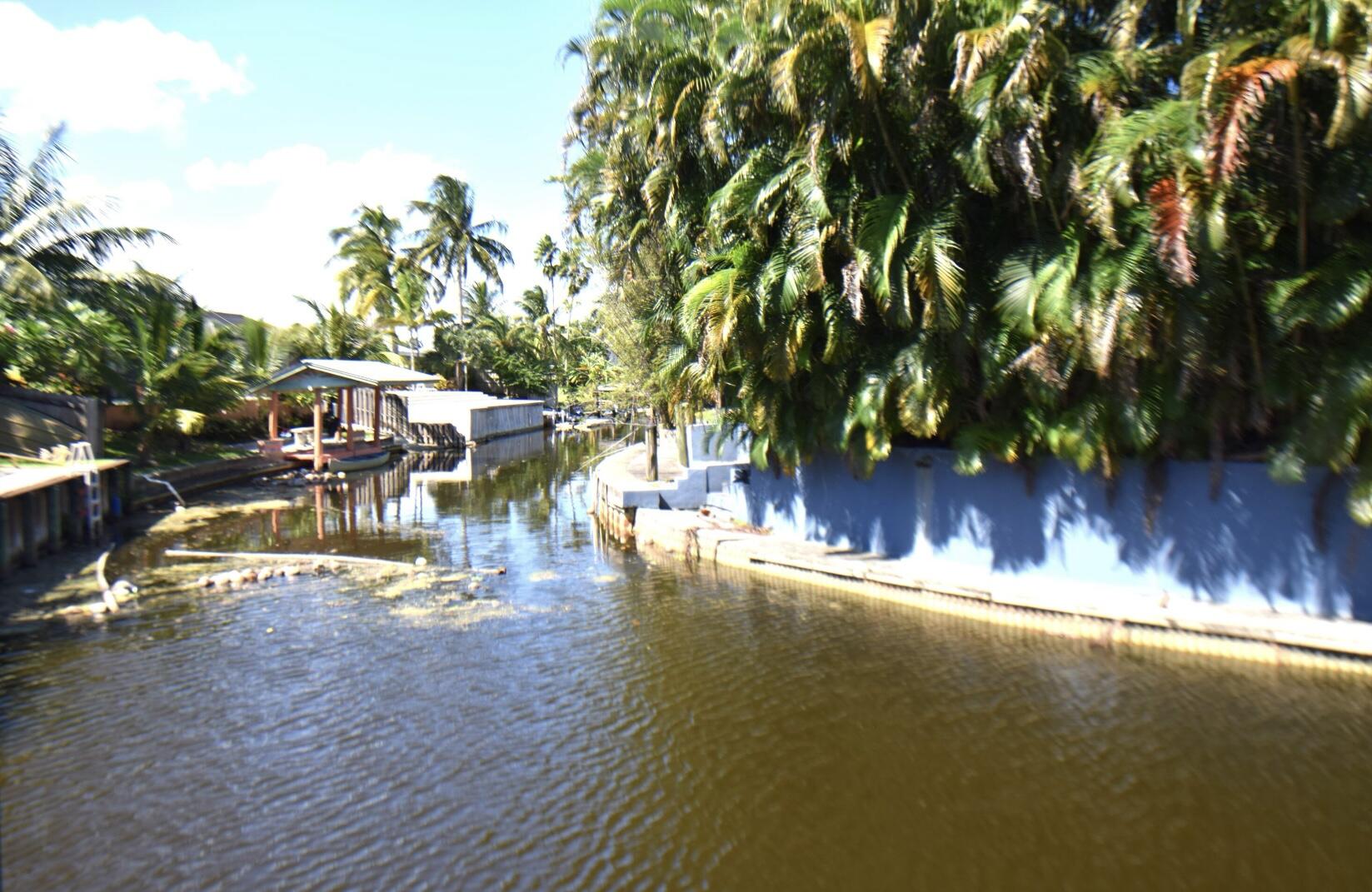 2215 Hypoluxo Road Lantana, FL 33462 - Photo 4 of 49 a view of a swimming pool with an outdoor space and seating area