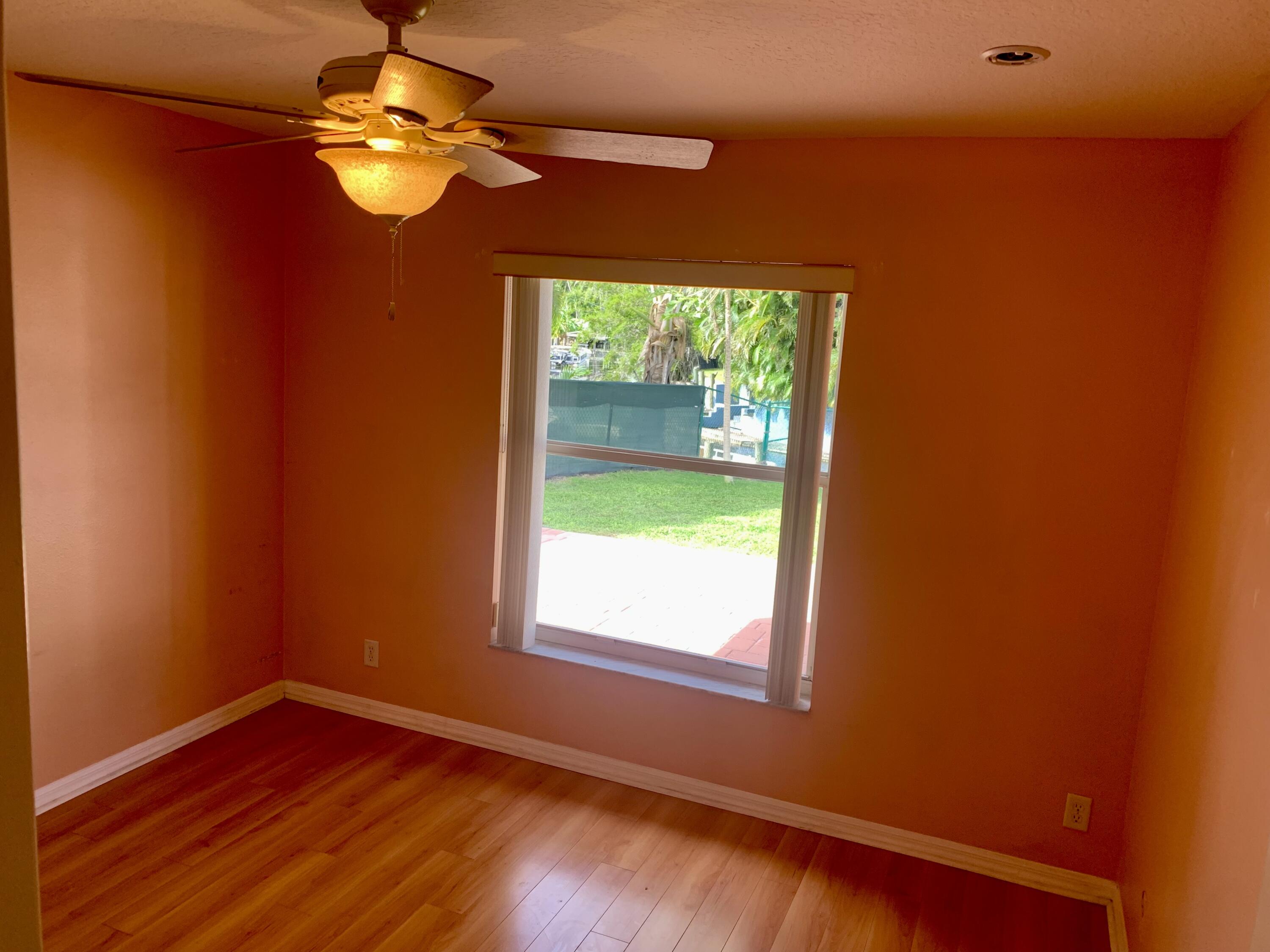 2215 Hypoluxo Road Lantana, FL 33462 - Photo 47 of 49 a view of empty room with wooden floor and fan