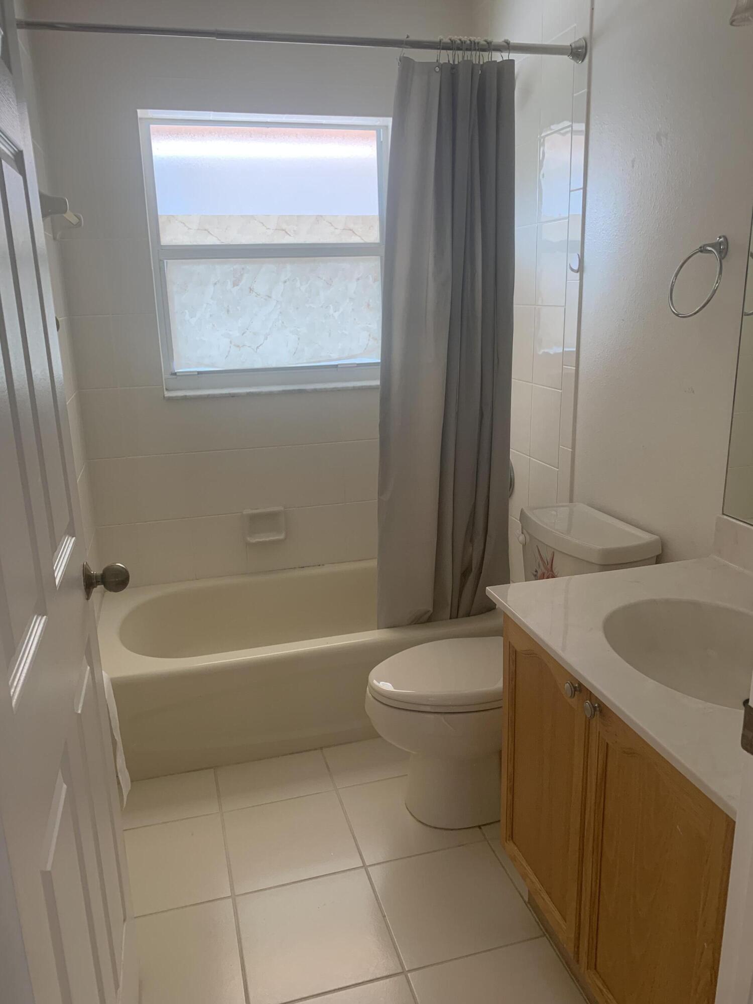 2215 Hypoluxo Road Lantana, FL 33462 - Photo 49 of 49 a bathroom with a sink a toilet and shower