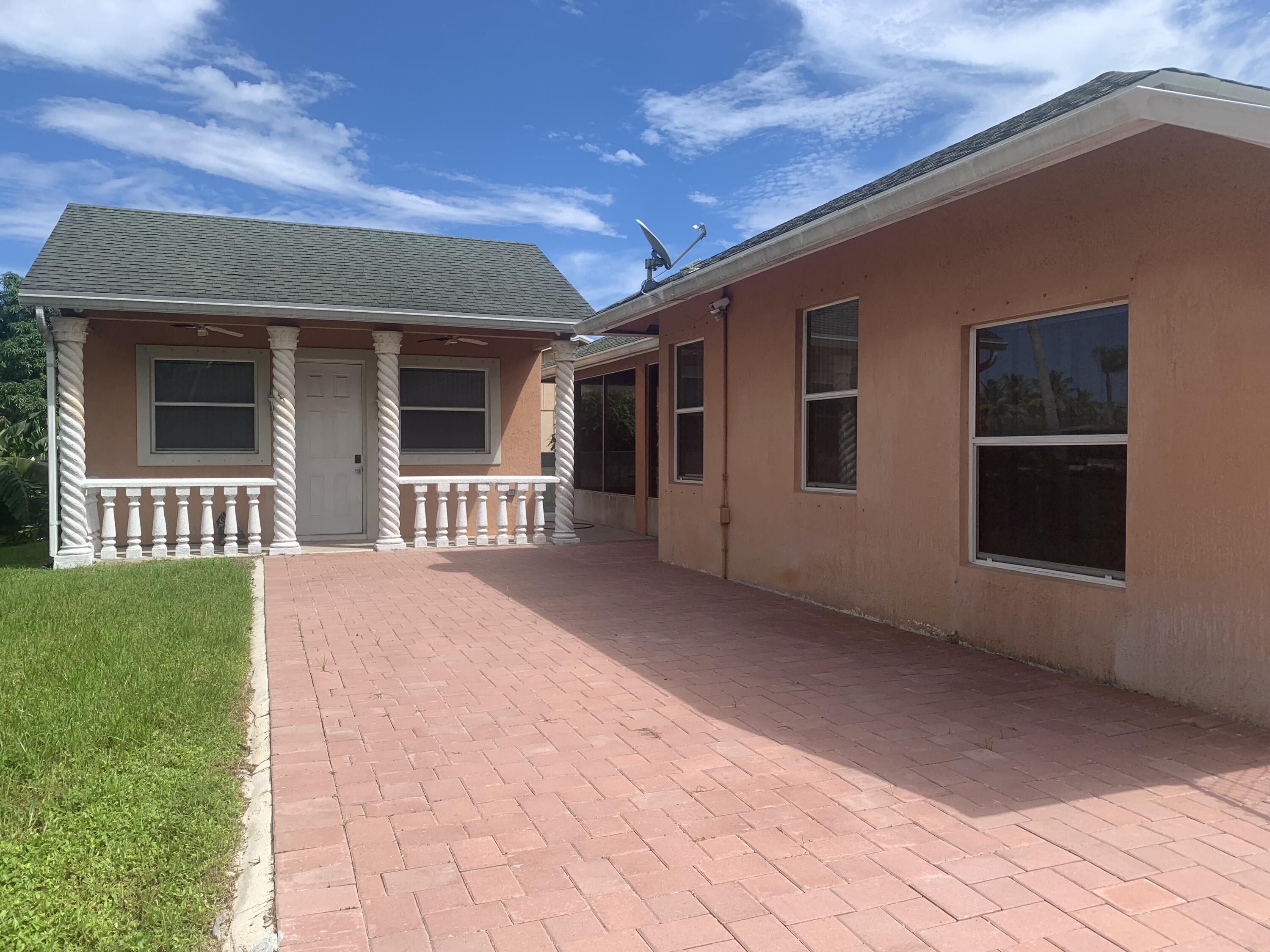 2215 Hypoluxo Road Lantana, FL 33462 - Photo 8 of 49 a front view of a house with a yard