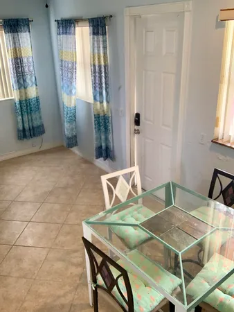 a dining room with furniture and window