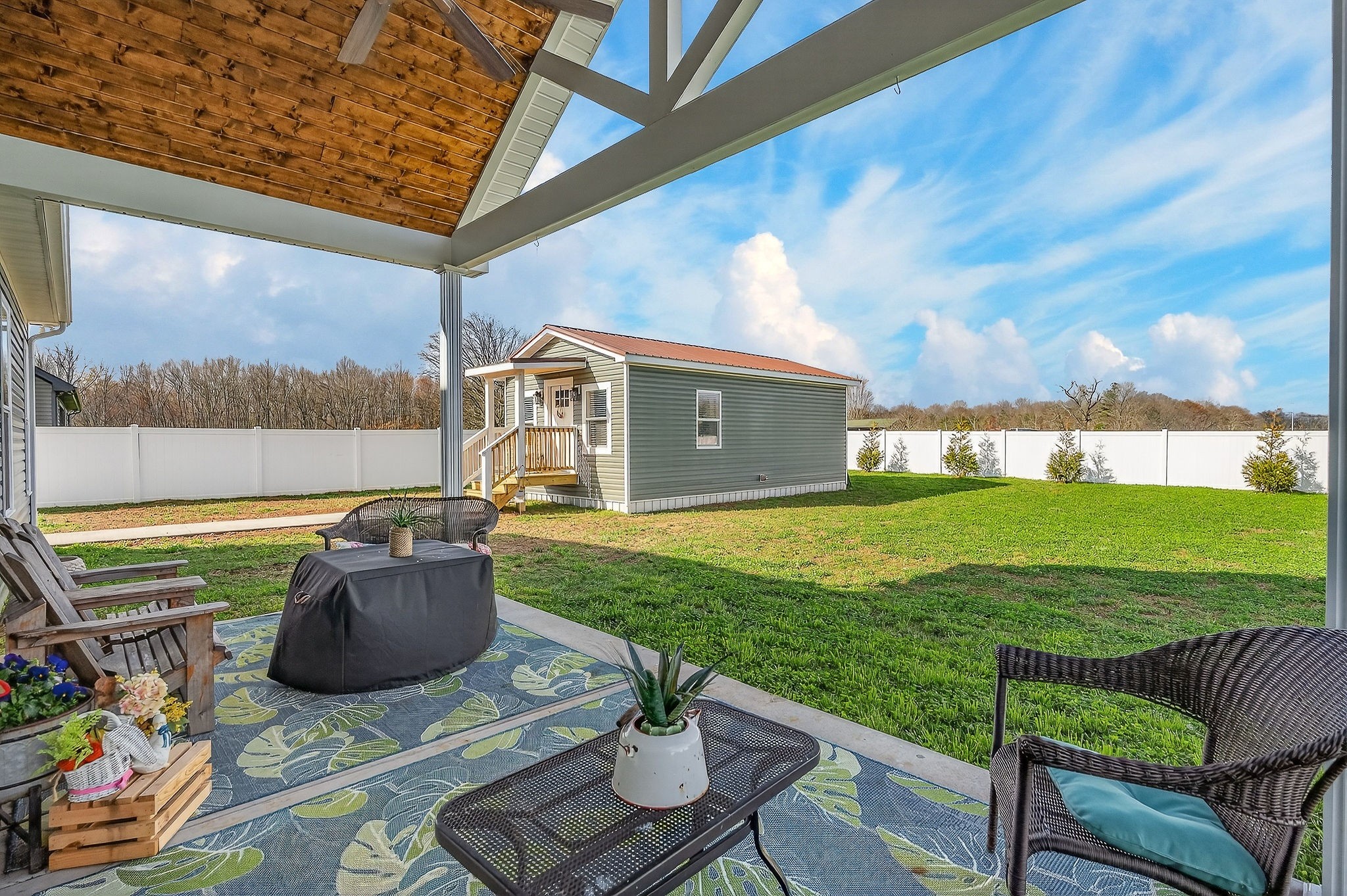 1073 Arch Cope Road Morrison, TN 37357 - Photo 36 of 42 a view of a patio with table and chairs potted plants with wooden floor and fence