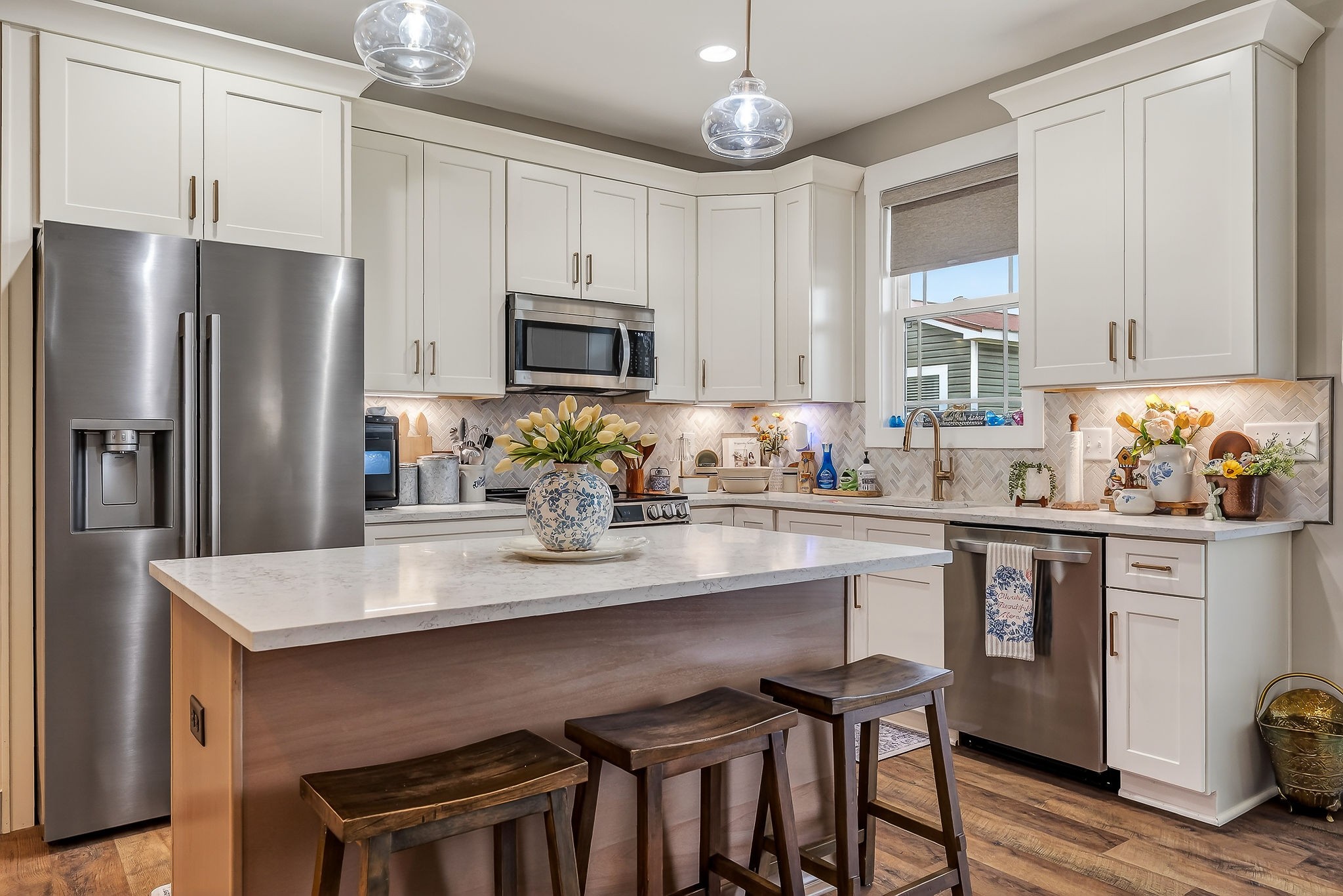 1073 Arch Cope Road Morrison, TN 37357 - Photo 6 of 42 a kitchen with stainless steel appliances granite countertop a stove refrigerator a sink dishwasher and microwave with wooden floor